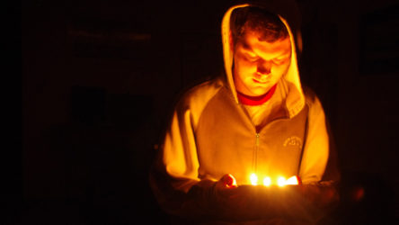 Nathaniel sitting on the coffee table during a power outage.